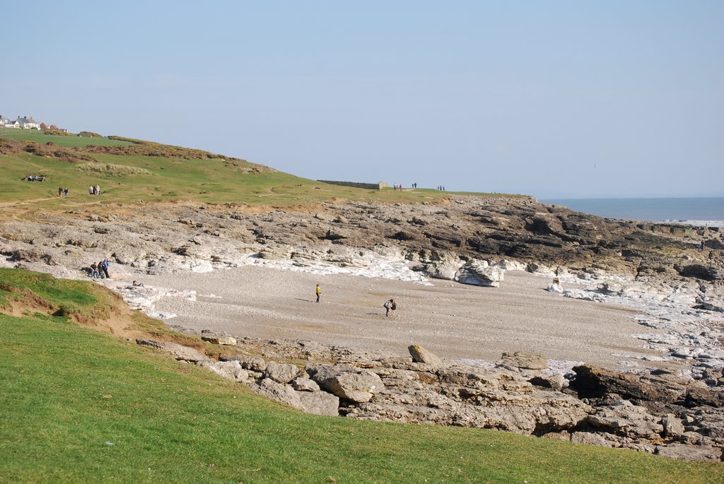 View of the coastal path at Ogmore showing a sandy beach and rocks.