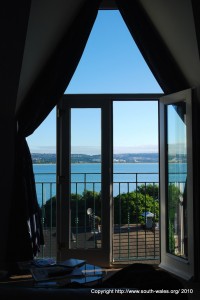 View of Swansea Bay through open door from room in Patricks